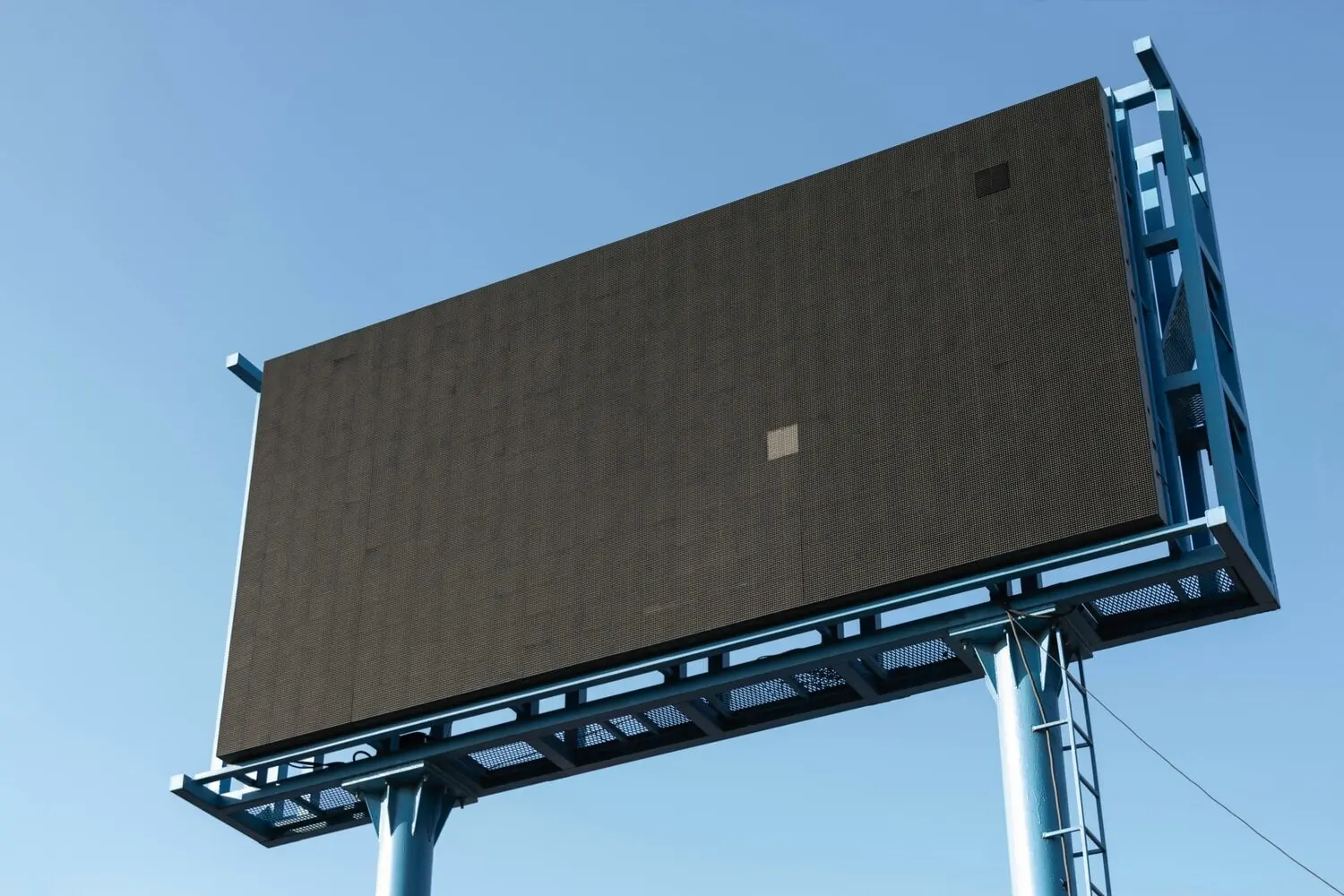 Photographie d’un grand panneau digital outdoor vide sous ciel bleu, illustrant la thématique des campagnes publicitaires extérieures au Maroc.